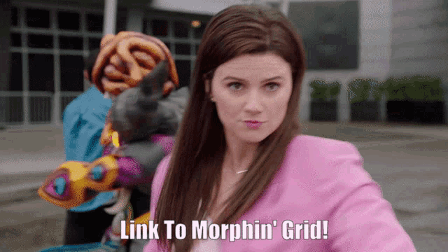 a woman says link to morphin ' grid while holding a stuffed animal