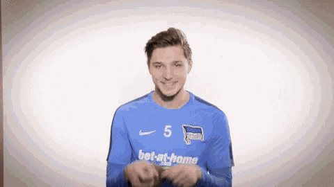 a soccer player wearing a blue jersey with the number 5 on it