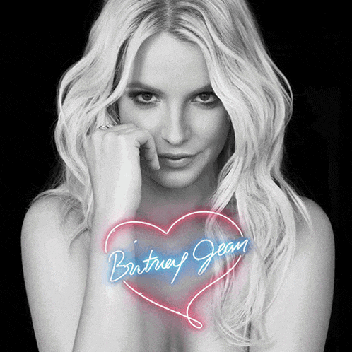 a woman with blonde hair and a neon heart that says britney jean