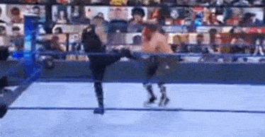 a couple of men are wrestling in a ring .