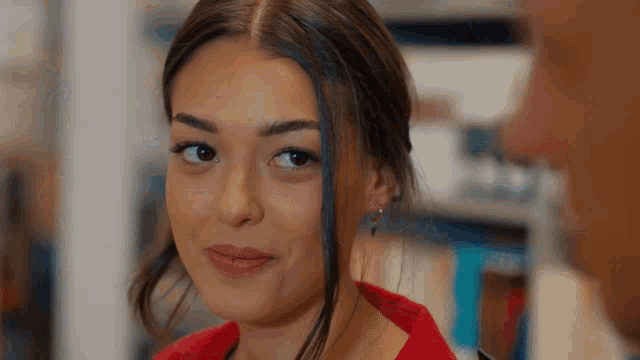 a woman in a red sweater looks at a man