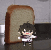 a stuffed toy is standing next to a slice of bread