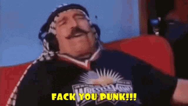 a man wearing headphones and a wrestlemania shirt is saying fack you dunk