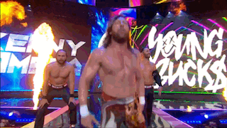 a group of men are standing in front of a sign that says " young sucks "