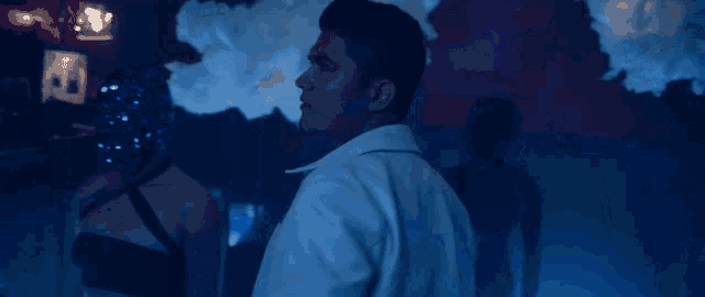 a man in a white jacket with a star pin