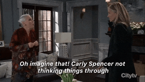 two women standing in a living room with the words oh imagine that carly spencer not thinking things through on the bottom