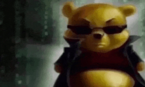 a winnie the pooh bear wearing sunglasses and a black jacket .