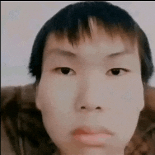 a close up of a person 's face with a very serious look on his face .