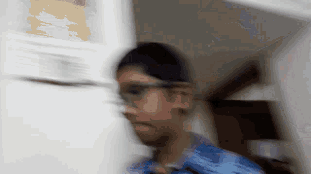 a blurry picture of a person standing in front of a white wall
