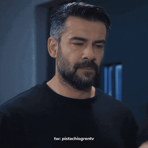 a man with a beard wearing a black shirt has tw pistachiogrentv written below him