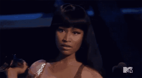 a woman says what 's good in front of a mtv sign