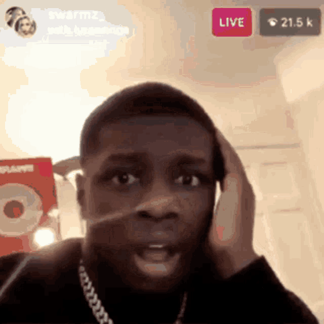 a man talking on a cell phone with a live button in the upper right corner