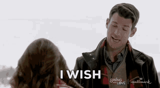 a man and a woman are standing in the snow and the man is saying `` i wish '' to the woman .