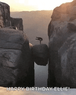 a person is doing a trick on a rock in the middle of a canyon .