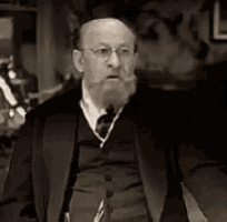 a man with a beard and glasses is wearing a suit
