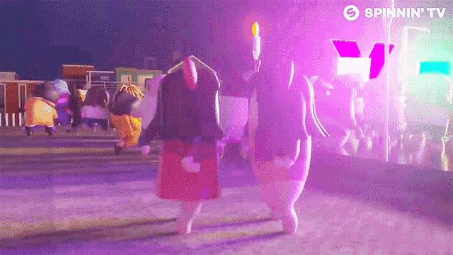 a couple of cartoon characters walking down a street with a spinnin ' tv logo behind them