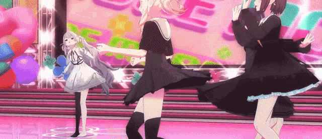 a group of anime girls are dancing on a stage with balloons in the background .
