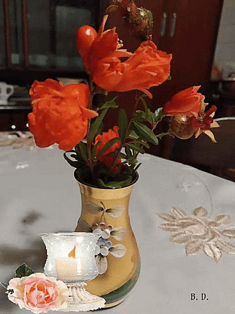 a vase filled with flowers and a candle on a table with b.d. written on the bottom