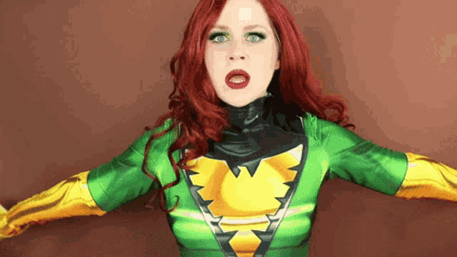 a woman with red hair is wearing a green and yellow superhero outfit