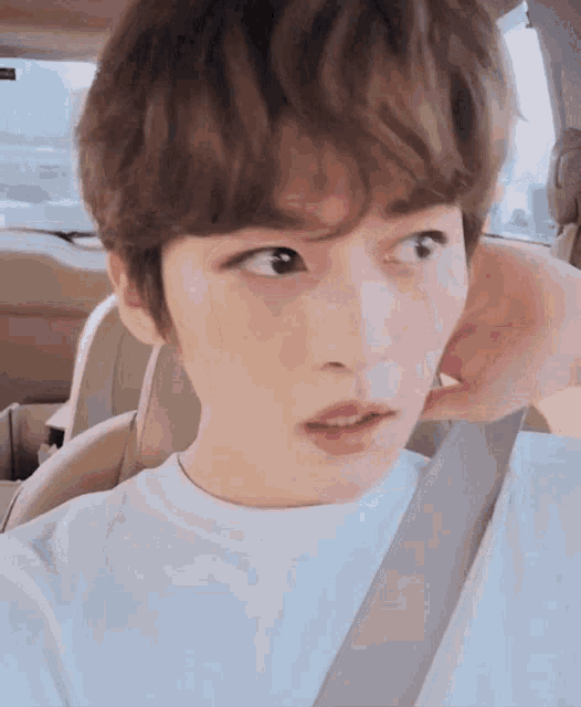 a close up of a person 's face while sitting in a car .