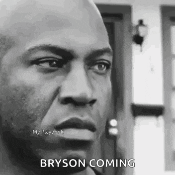 a black and white photo of a man with a surprised look on his face and the words bryson coming .