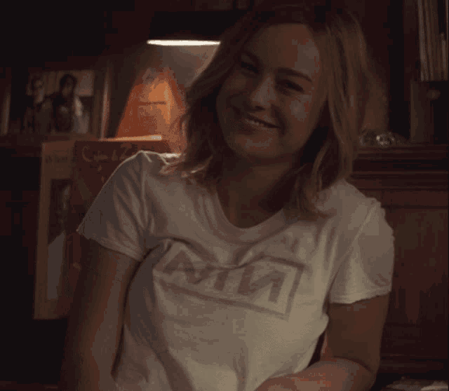 a woman wearing a white t-shirt that says mtv on it