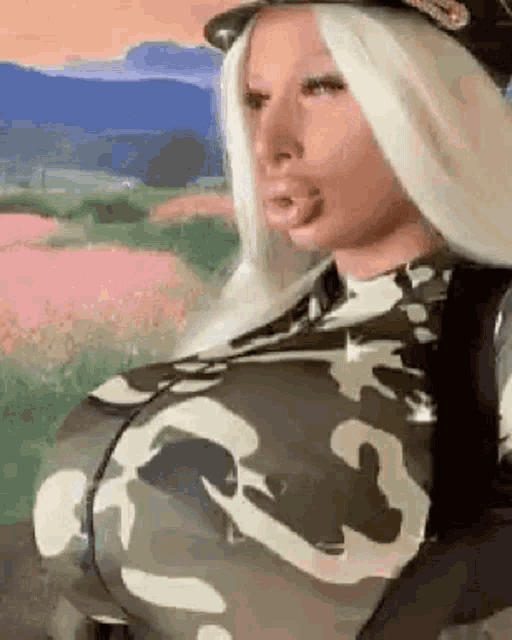 a woman with very large breasts is wearing a camouflage outfit .