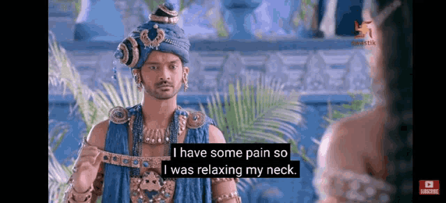 a man in a blue turban is talking to a woman and says `` i have some pain so i was relaxing my neck ''
