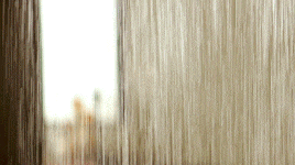 a blurry picture of a window with a reflection of a building
