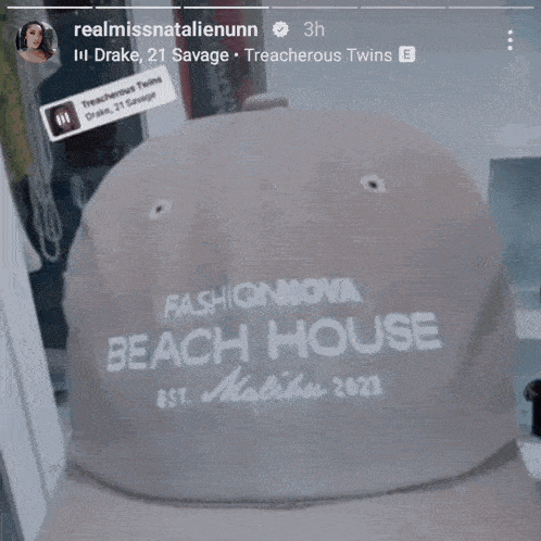a person wearing a hat that says beach house