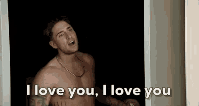 a shirtless man is standing in a doorway and saying `` i love you '' .