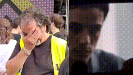 a man in a yellow vest is covering his face with his hands