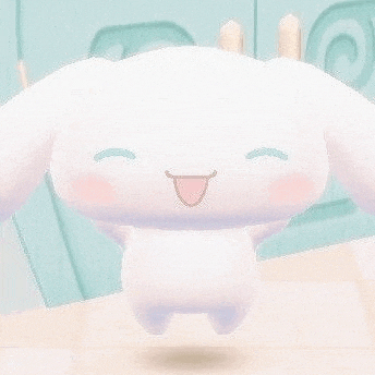 a white stuffed animal with a tongue sticking out is sitting on top of a table .