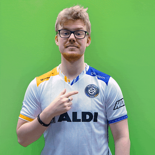 a man wearing a white shirt with the word aldi on the front