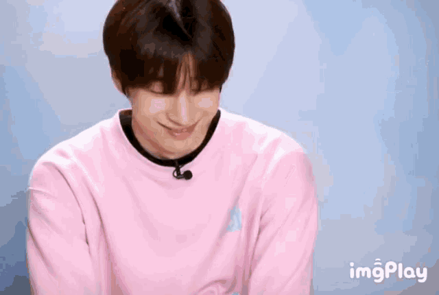 a man wearing a pink shirt with a plan a written on it