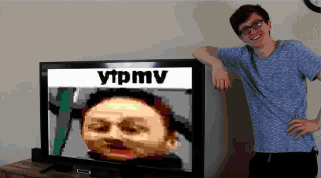 a man is standing in front of a tv screen that says ytpmv