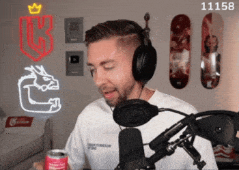 a man wearing headphones and holding a can of budweiser