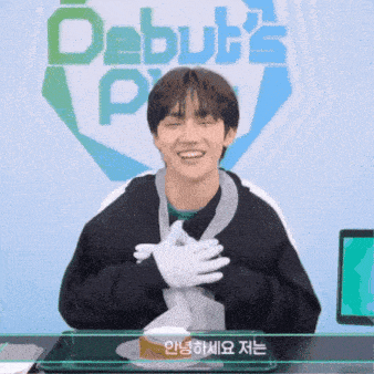 a young man is smiling in front of a sign that says debut 's p