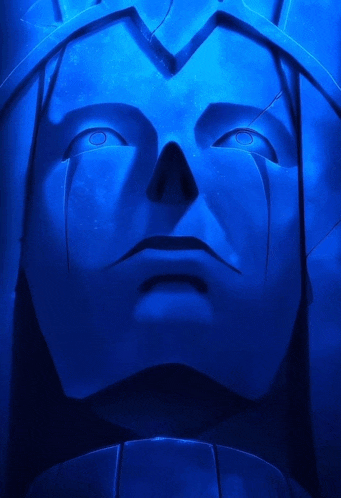 a statue of a man 's face is lit up with blue light