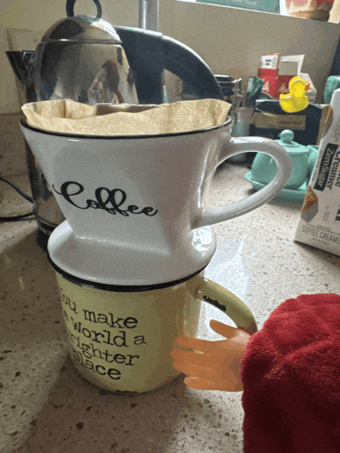 a cup that says " you make the world a brighter place " on it