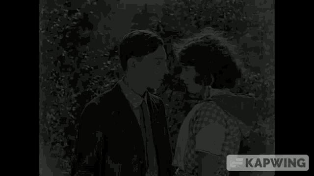 a man and a woman are looking at each other in a black and white photo with kapwing written on the bottom