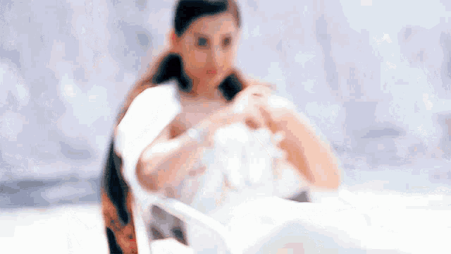 a woman sitting in a chair with her hands folded