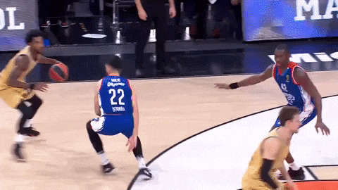 a basketball player with the number 22 on his back is dribbling the ball