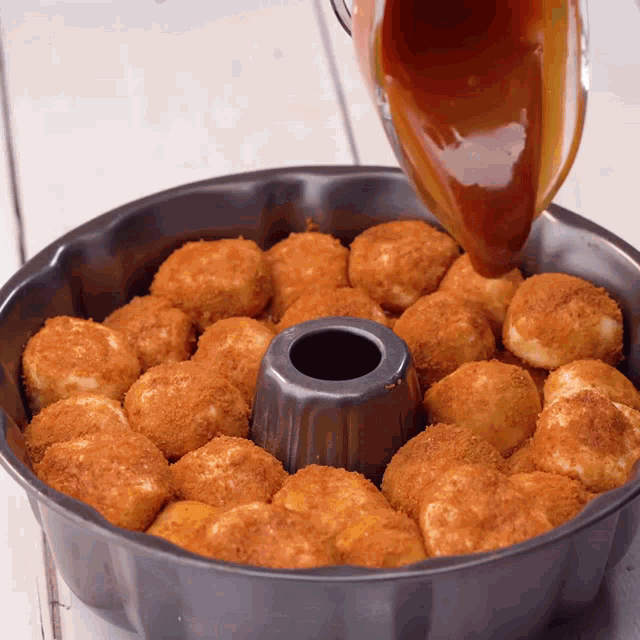 a bundt cake with a hole in the middle is being poured with caramel