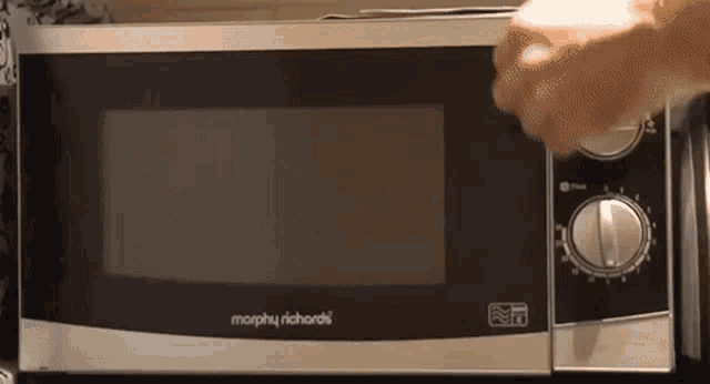 a morphy richards microwave is being used to cook something
