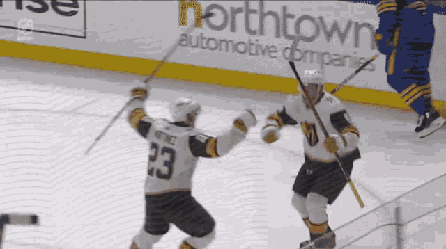 a hockey player with the number 23 on his jersey celebrates a goal