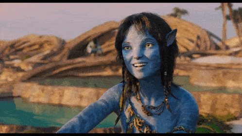 a woman in a blue avatar costume is smiling in front of a pool