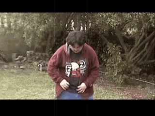 a man in a red sweatshirt with the letter g on it