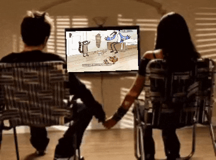 a man and a woman are holding hands while watching a regular show on television