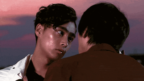 two men are looking at each other and one has a tear running down his face